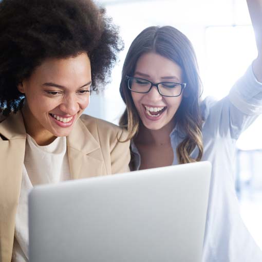 Two businesspeople cheering successful outcome.