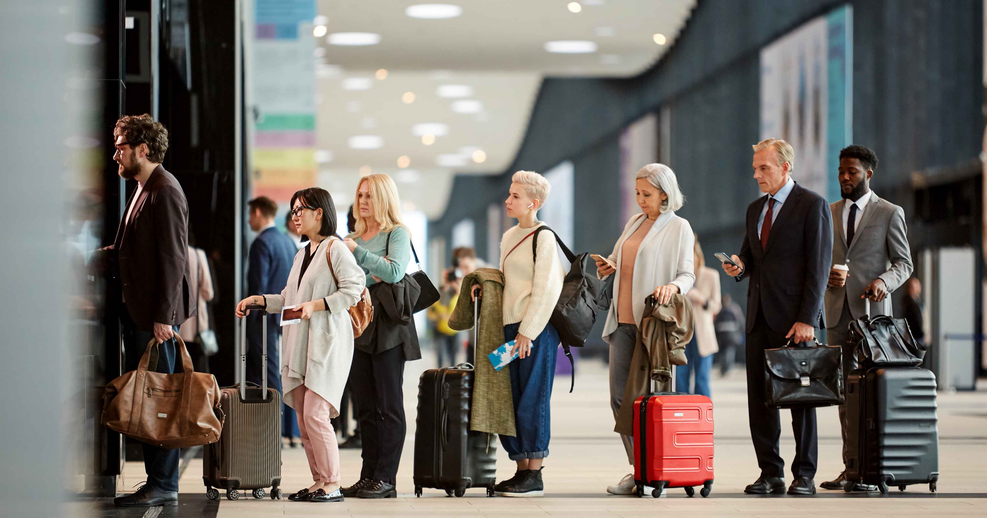 An image of people queueing at an airport.